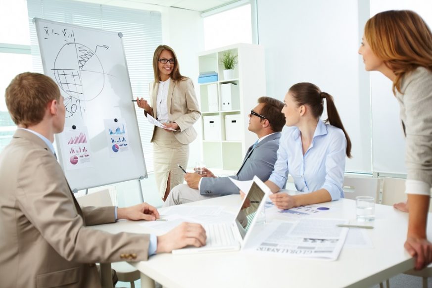 13729495 - confident top manager standing by the whiteboard and explaining her strategy at meeting